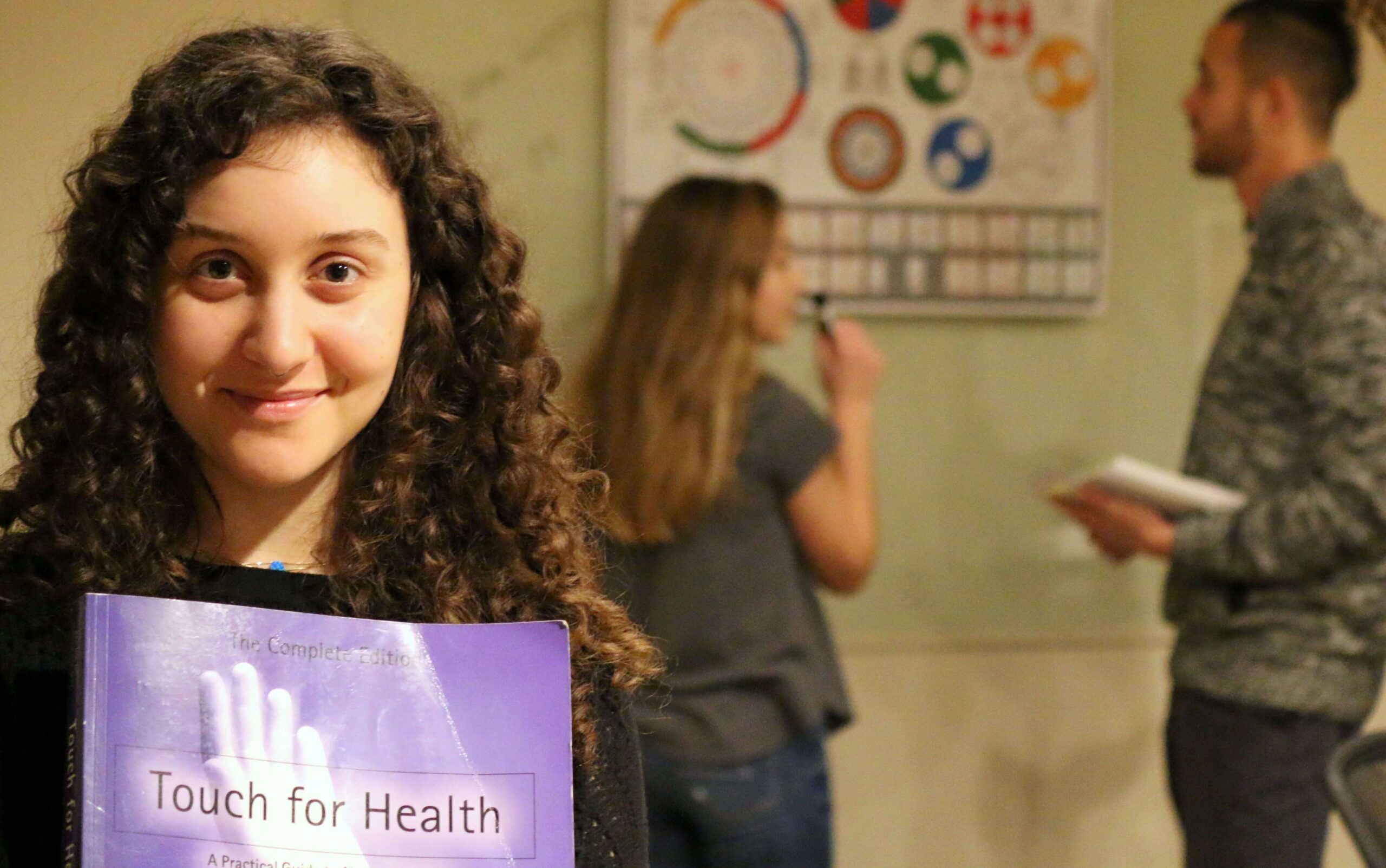 Woman holding Touch for Health book