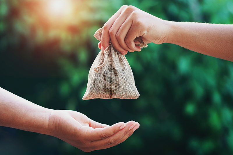 Person handing money to a friend