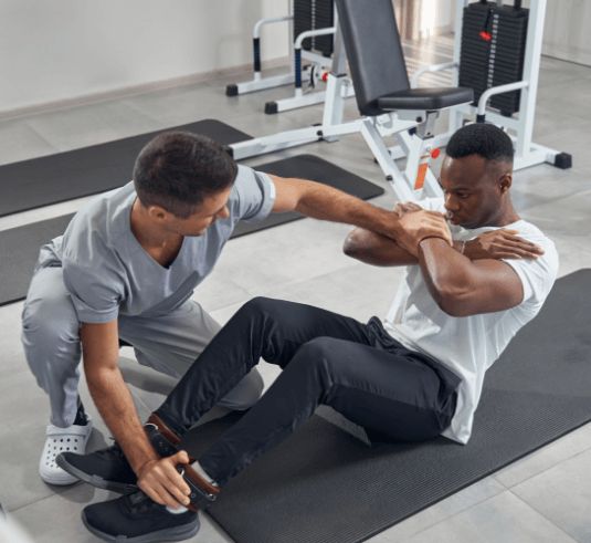 Sports coaching helping athlete stretch