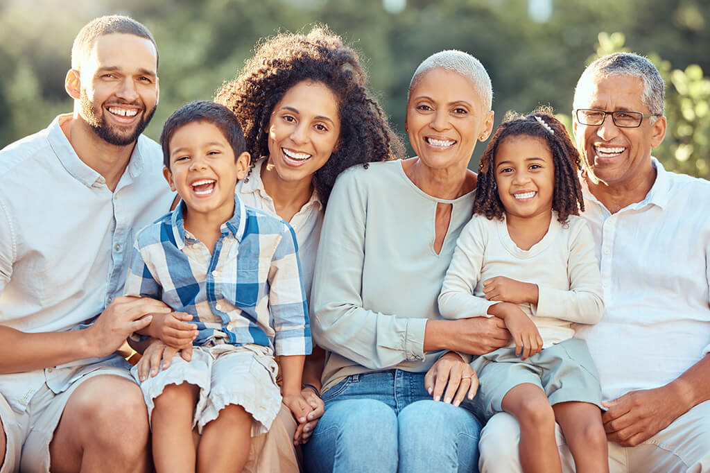 Grandparents, parents, and children smiling for a photo