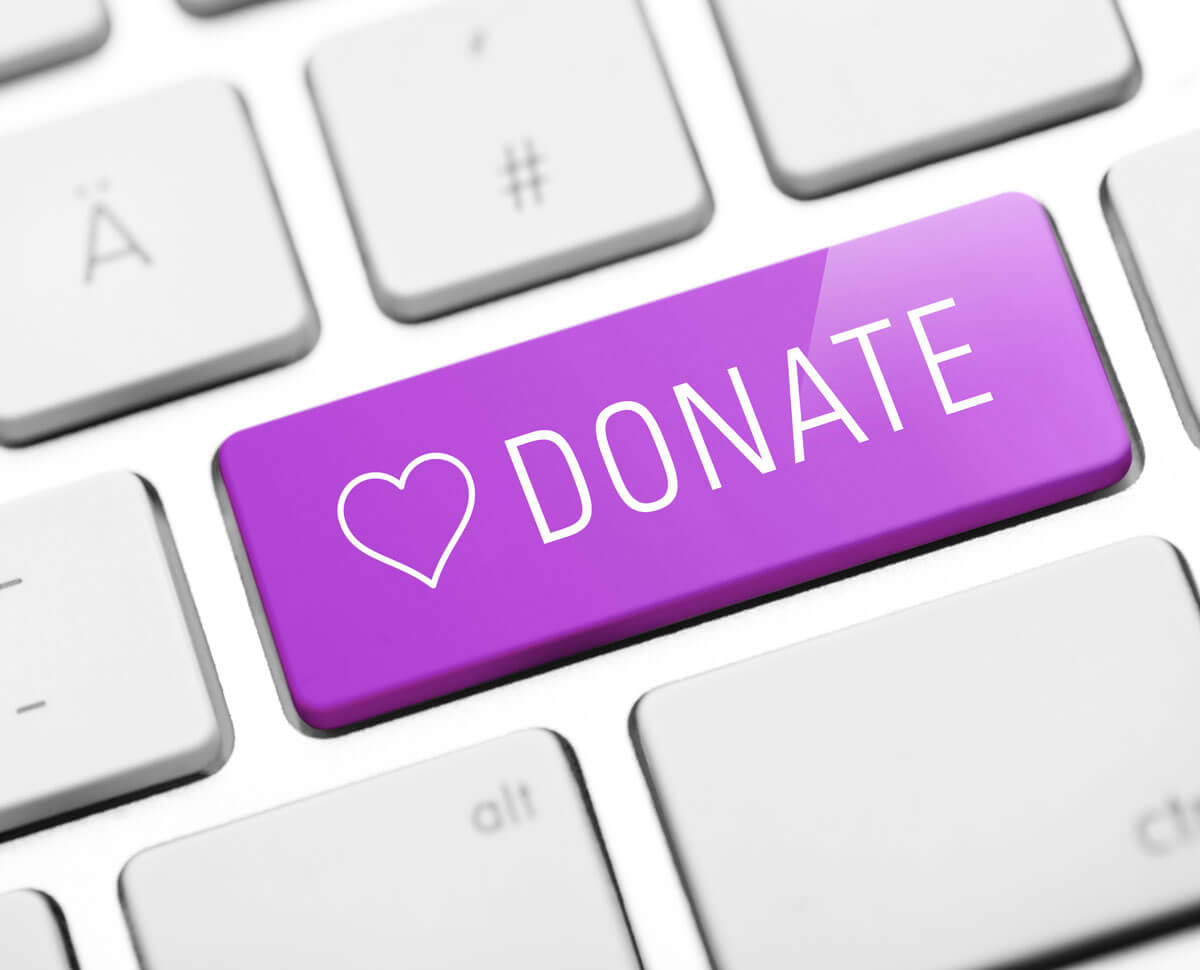 computer keyboard with a purple donate button